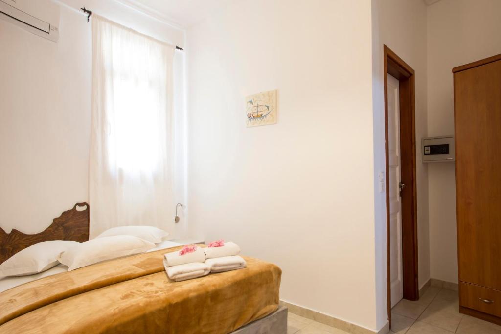A bed or beds in a room at Birds Villa Apartments - Including Car Rental