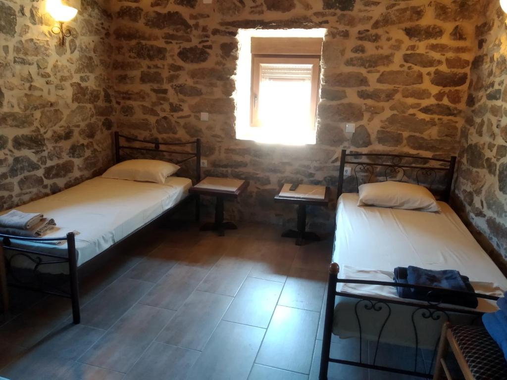 A bed or beds in a room at panos stone tower