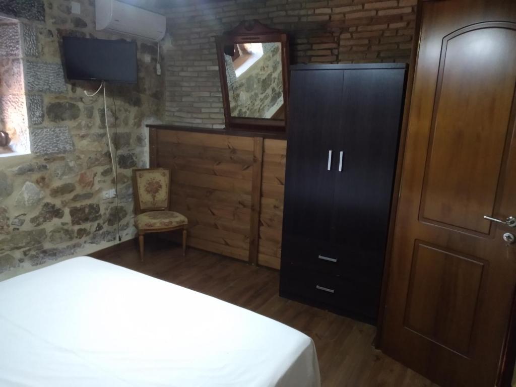 A bed or beds in a room at panos stone tower