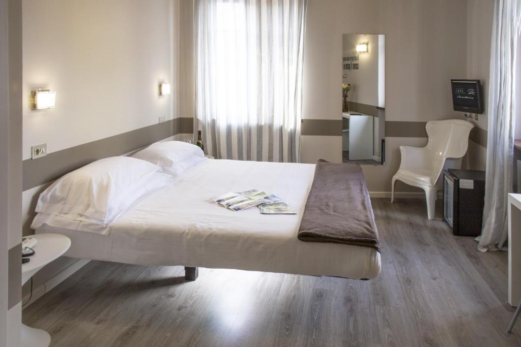 Postel nebo postele na pokoji v ubytování Albergo Al Cacciatore Tortellinando