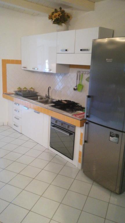 a kitchen with a stainless steel refrigerator and a sink at Guest House Di Bartolomeo in Capaccio-Paestum