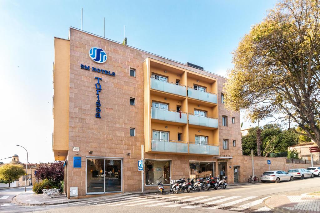 a building with motorcycles parked in front of it at Hotel Turissa in Tossa de Mar