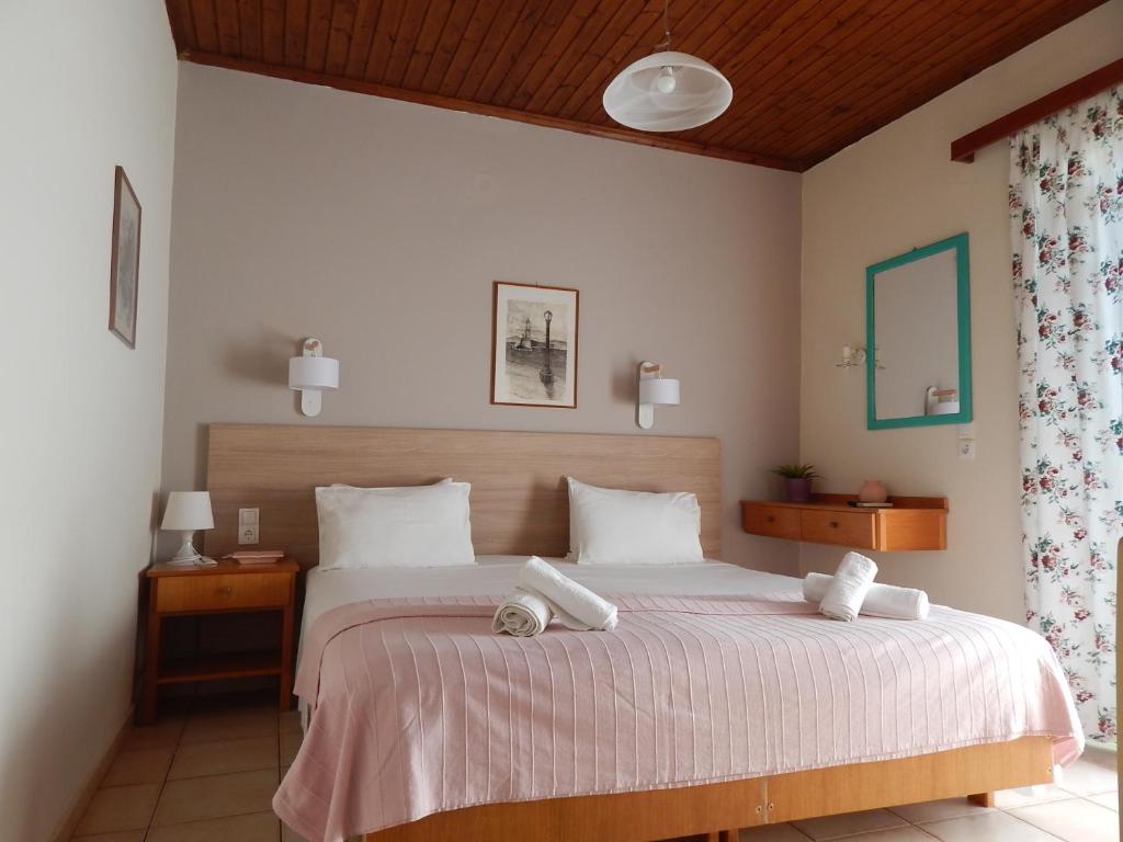 a bedroom with a bed with two towels on it at Posidonio Hotel in Chania
