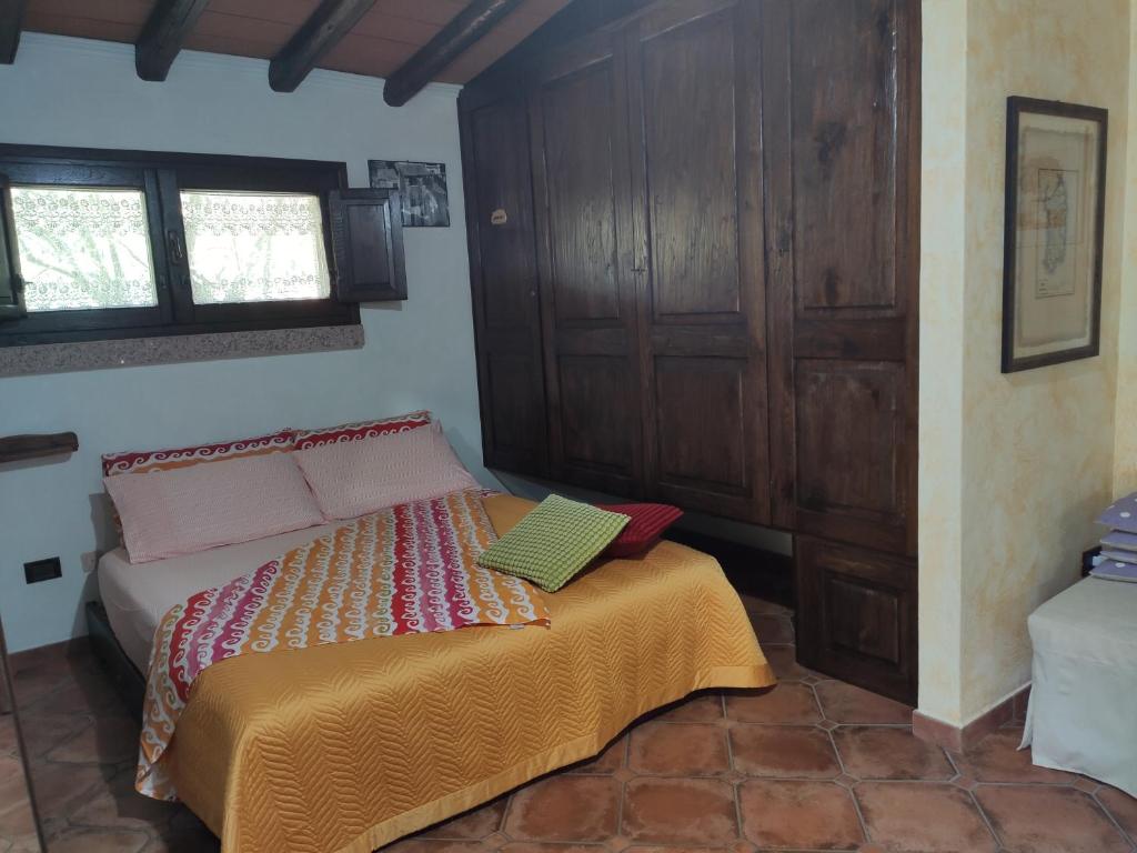 a bedroom with a bed with two books on it at Casa Bados in Dorgali