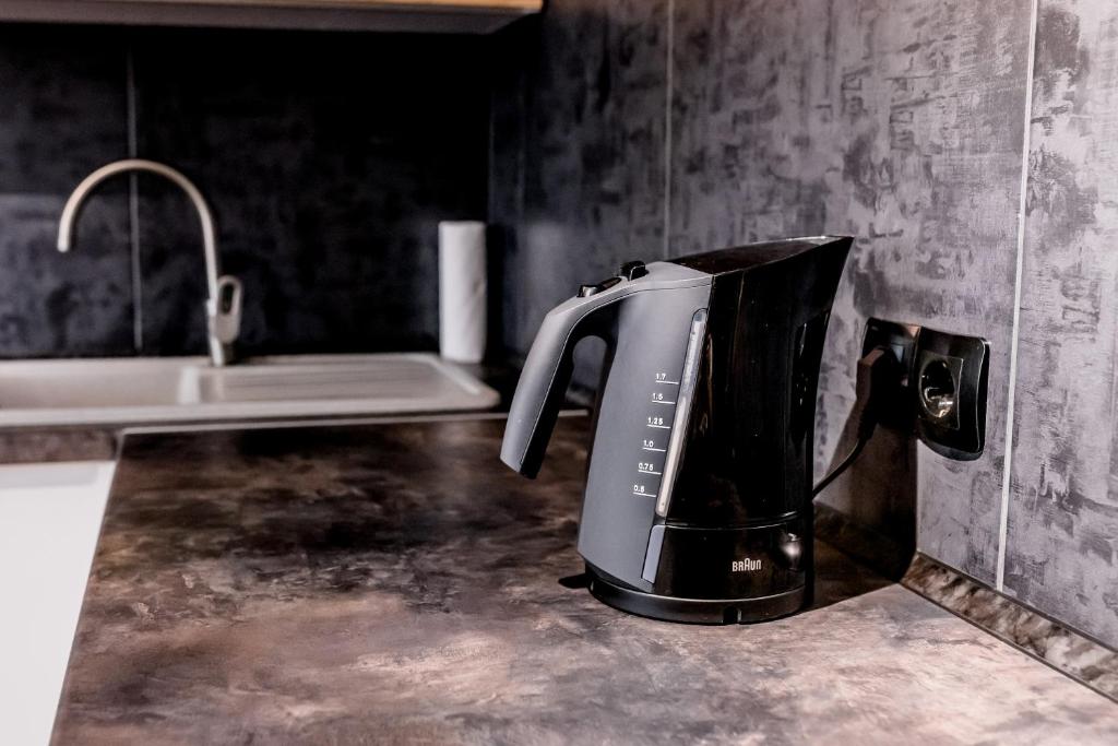 a toaster sitting on a counter in a kitchen at Апартаменти VIP в центрі Чорткова in Chortkiv