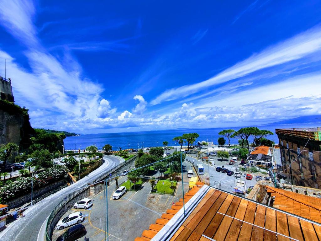 a view of a city with the ocean in the background at Hotel Il Faro in Sorrento