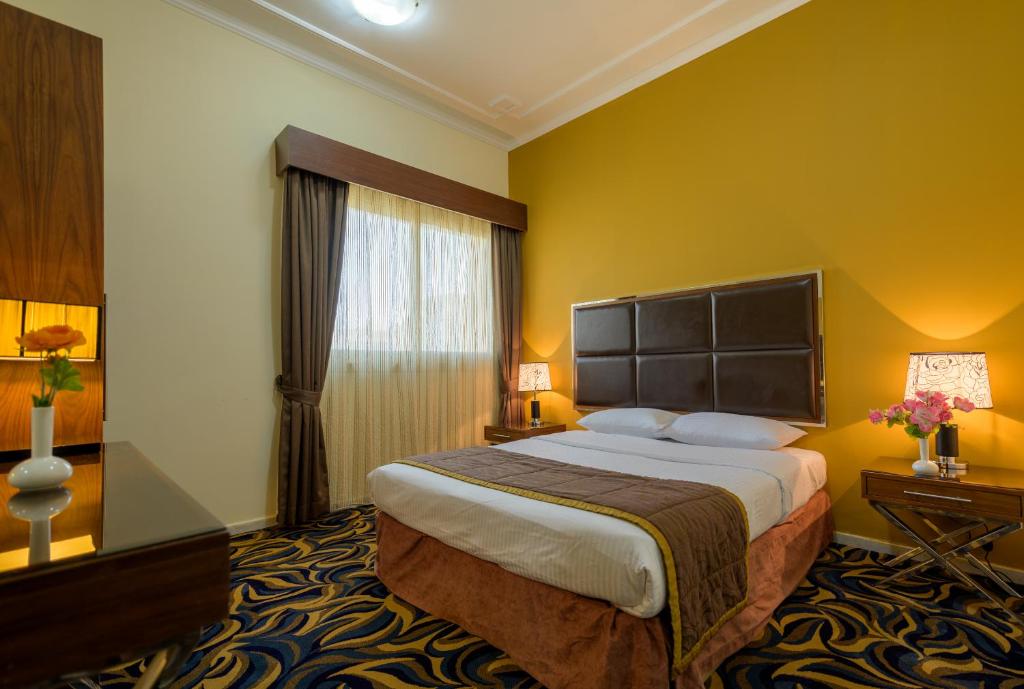 Кровать или кровати в номере Downtown Plaza Hotel Apartment Pet Friendly