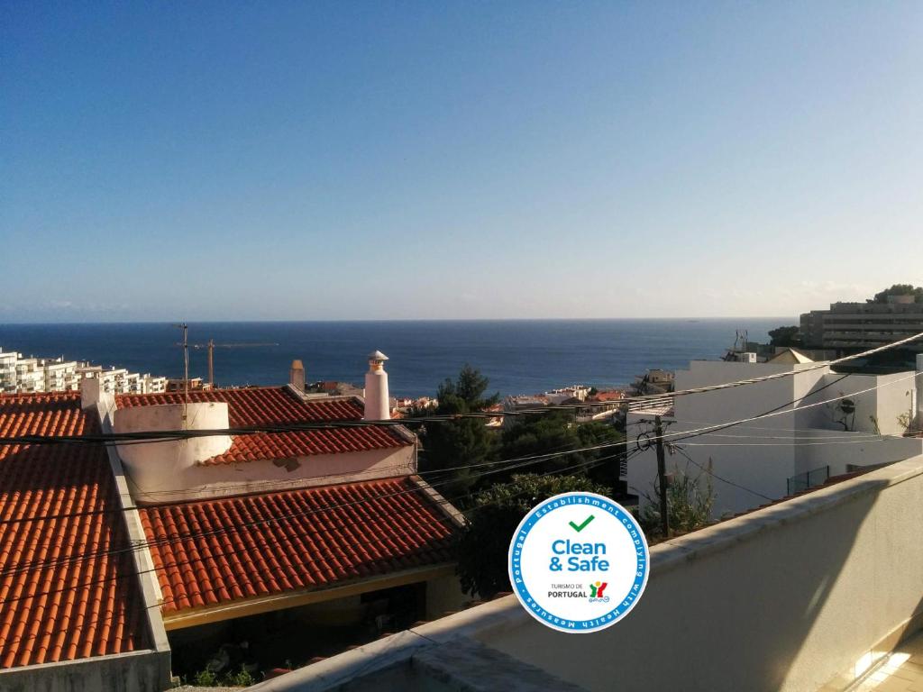 a view of the ocean from the roof of a building at Lá em Cima in Sesimbra