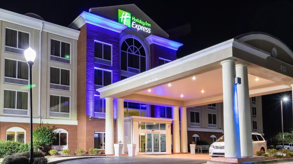 a hotel exterior at night with a lit up building at Holiday Inn Express Birmingham Irondale East, an IHG Hotel in Birmingham