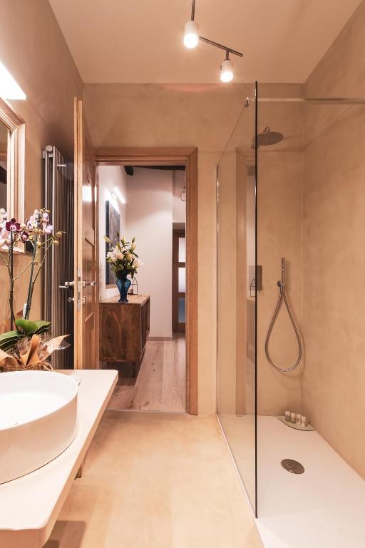 a bathroom with a tub and a sink and a shower at Drogheria e Locanda Franci in Montalcino
