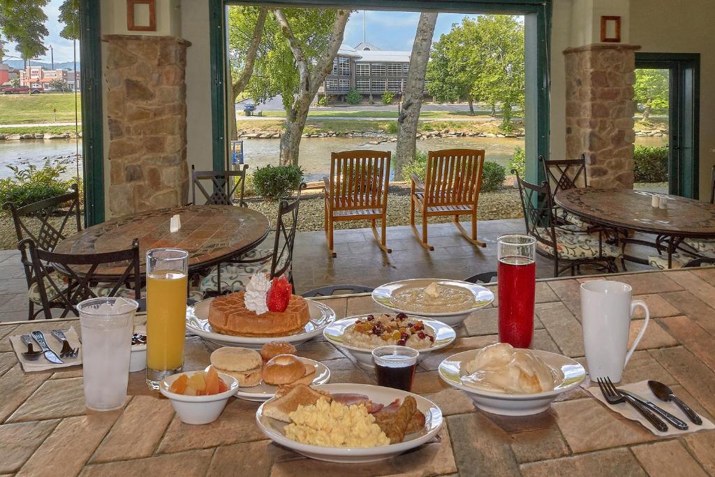 a table with plates of food on top of it at The Inn On The River in Pigeon Forge