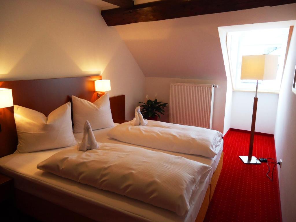 Postel nebo postele na pokoji v ubytování Hotel Gasthof Posthalter