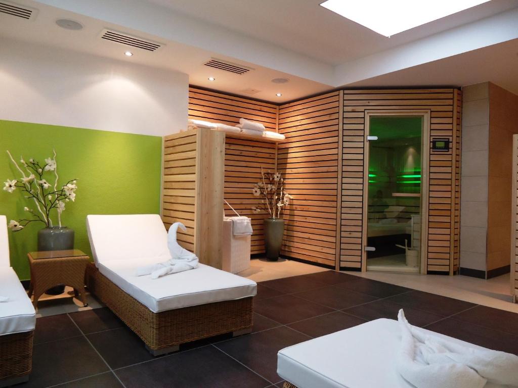 ツヴィーゼルにあるHotel Gasthof Posthalterの緑の壁の客室で、ベッド2台が備わります。
