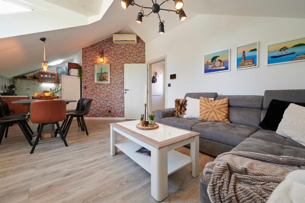 uma sala de estar com um sofá e uma mesa em Apartment Ana-Marija em Trogir