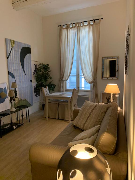 a living room with a couch and a table at Apartment Limas in Avignon
