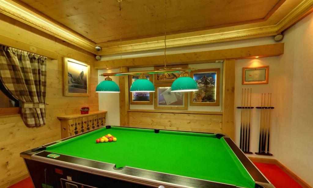 a billiard room with a green pool table at Hotel & Spa Le Dahu in Morzine