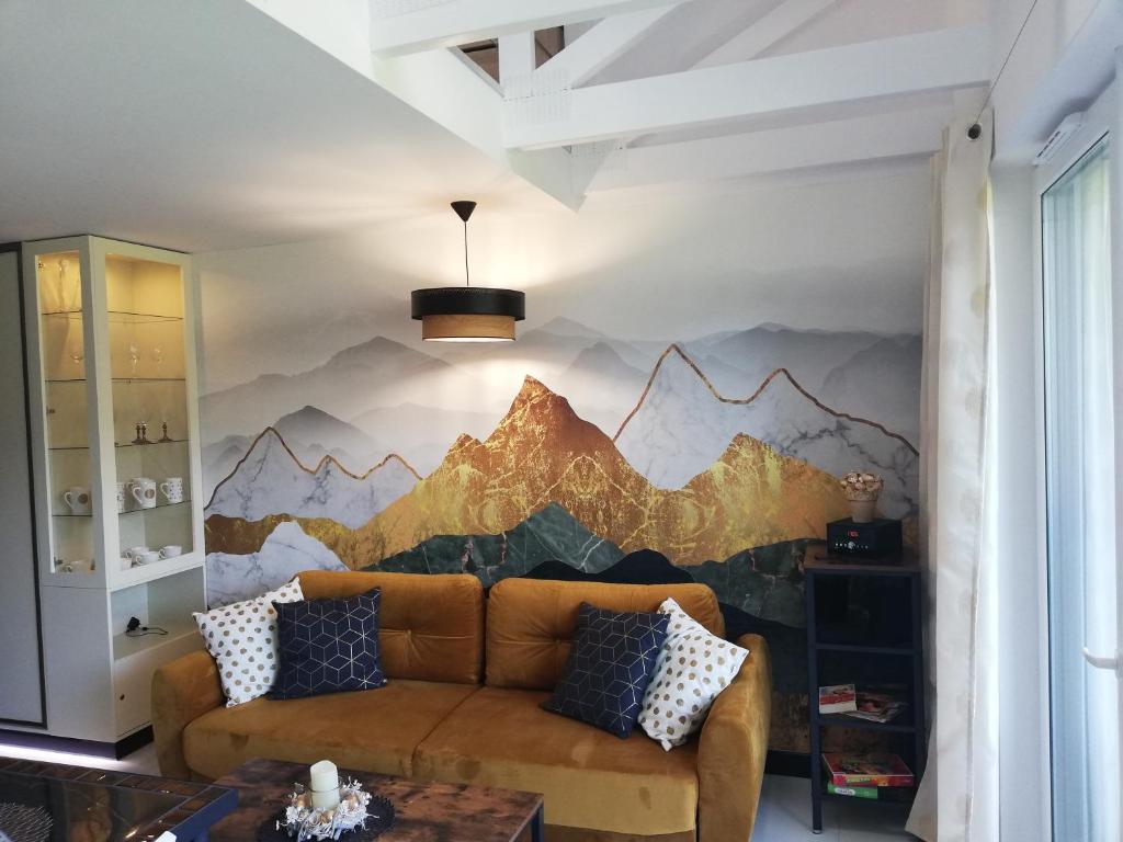 a living room with a mountain mural on the wall at Apartament K2 in Szczyrk