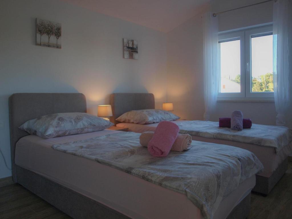 Postel nebo postele na pokoji v ubytování Apartmani Goga 2