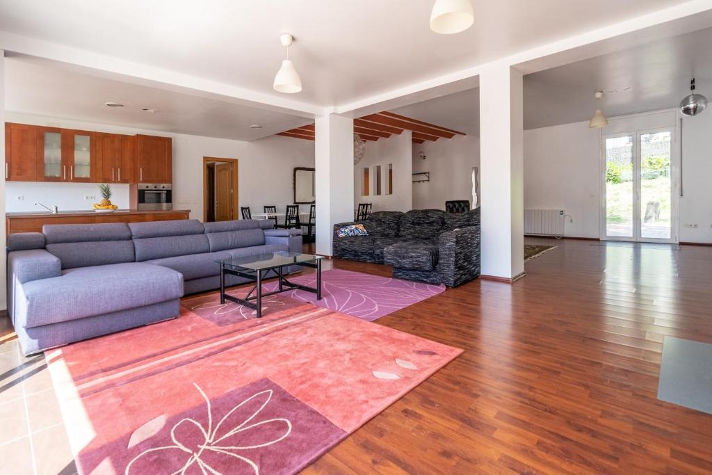 a living room with a couch and a table at Villa Auba Lloret in Lloret de Mar