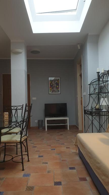 Televízia a/alebo spoločenská miestnosť v ubytovaní Apartmani N.May's