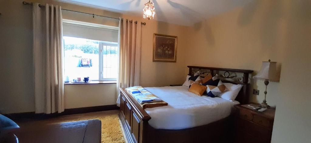 a bedroom with a large bed and a window at Creevagh (Room Only) in Keel