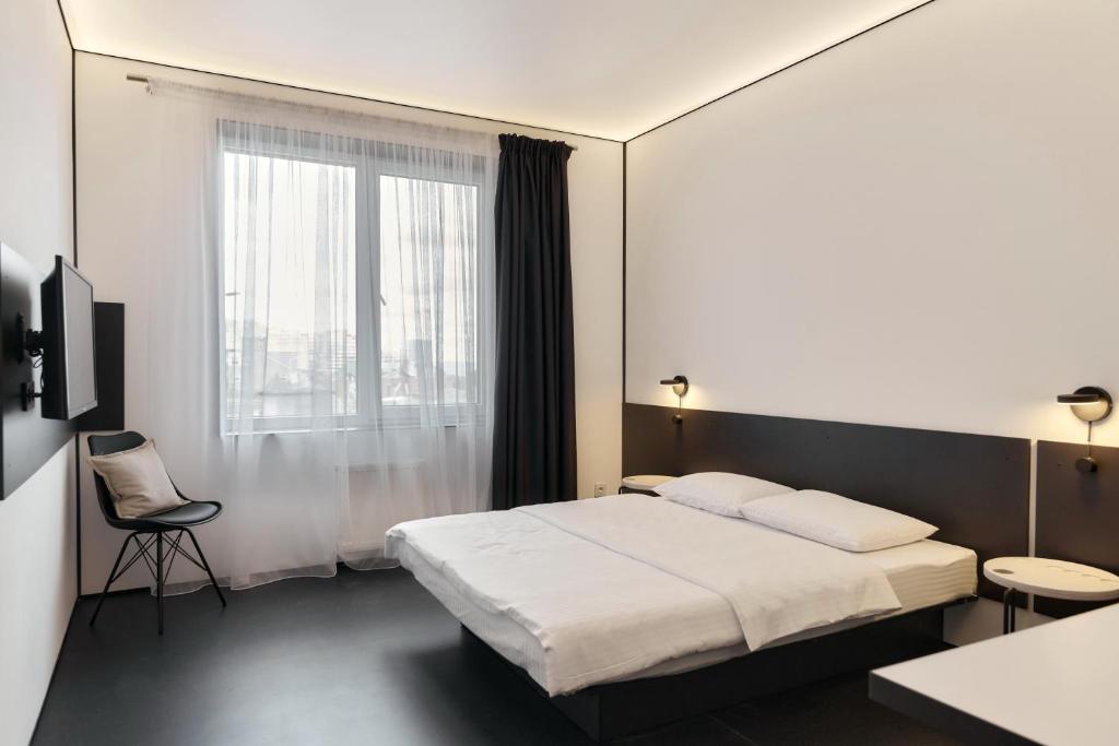 Postel nebo postele na pokoji v ubytování Atmosfera Hotel