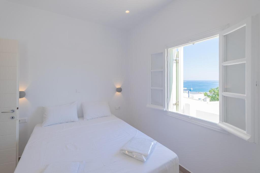 A bed or beds in a room at Lorenzo Studios and Suites Paros