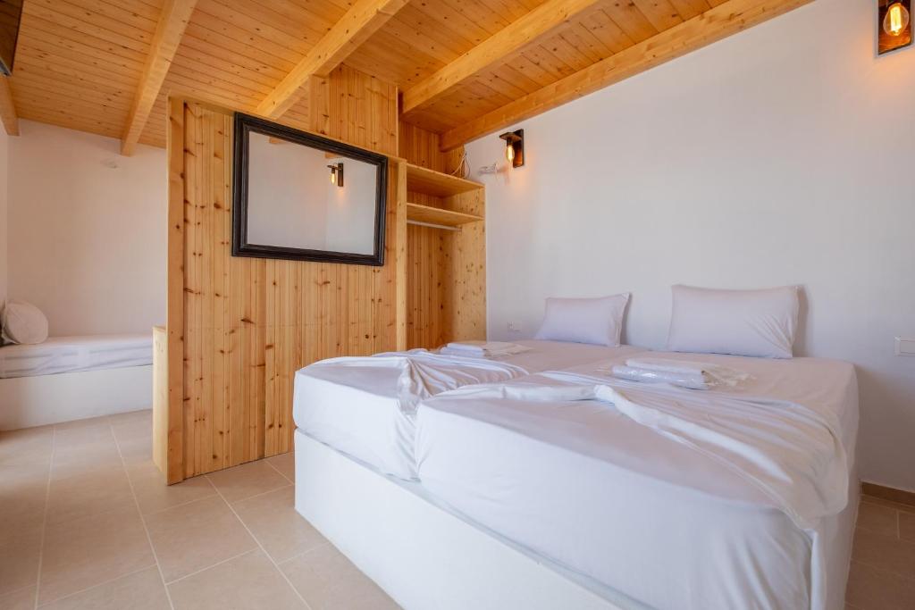 A bed or beds in a room at Lorenzo Studios and Suites Paros