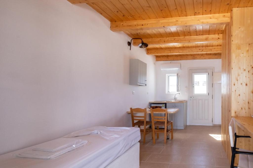 A bed or beds in a room at Lorenzo Studios and Suites Paros