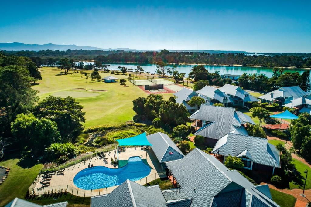 an aerial view of a resort with a golf course at Riverside Holiday Resort Urunga in Urunga