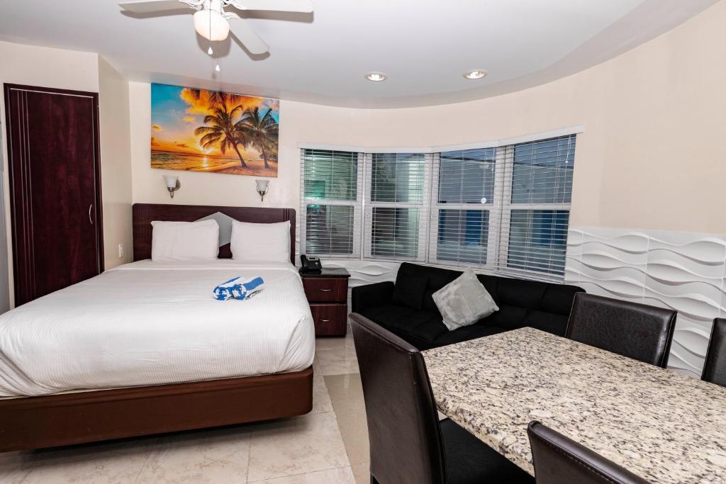 a hotel room with a bed and a couch at Caribbean Resort by the Ocean in Hollywood