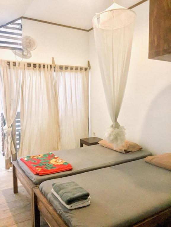 Postel nebo postele na pokoji v ubytování BK Homestay, Batukaras