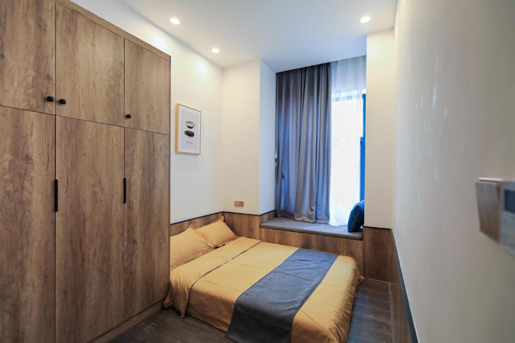 Postel nebo postele na pokoji v ubytování Shenzhen Ruiya Japanese-style Hotel Huaqiang North