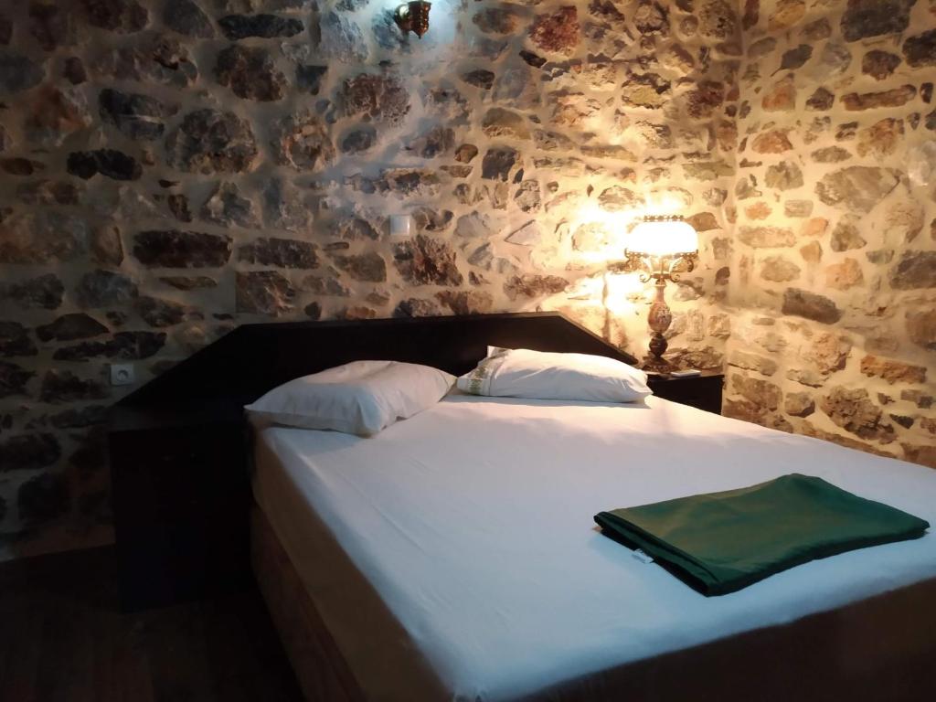 A bed or beds in a room at panos stone tower