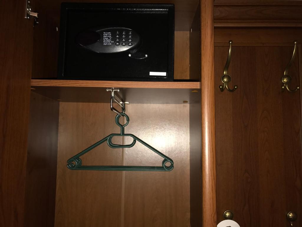 a microwave on top of a wooden cabinet at Antik Hotel Sofia in Litomyšl