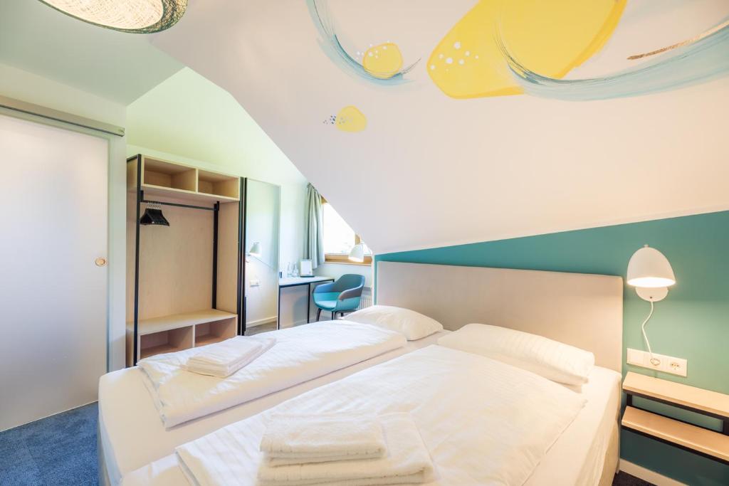 Postel nebo postele na pokoji v ubytování Hotel & Restaurant Mühlenglück