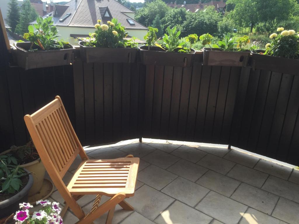 a chair sitting on a patio with a fence at Antik Hotel Sofia in Litomyšl