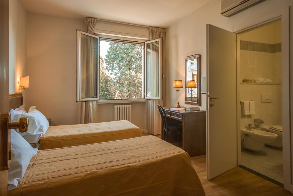 Postel nebo postele na pokoji v ubytování Hotel La Pace