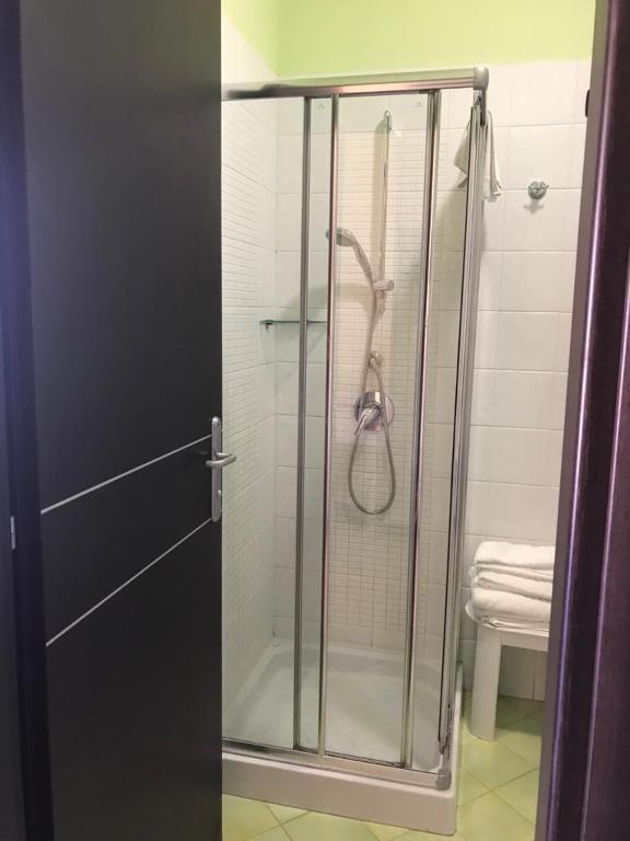 a shower with a glass door in a bathroom at Castellammare Smart Rooms in Castellammare del Golfo