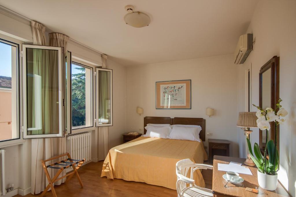 Postel nebo postele na pokoji v ubytování Hotel La Pace