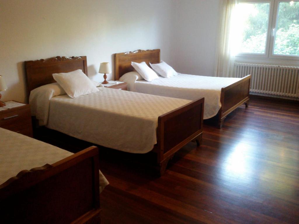 A bed or beds in a room at Hostal Pumar