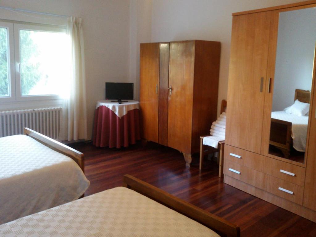 A bed or beds in a room at Hostal Pumar