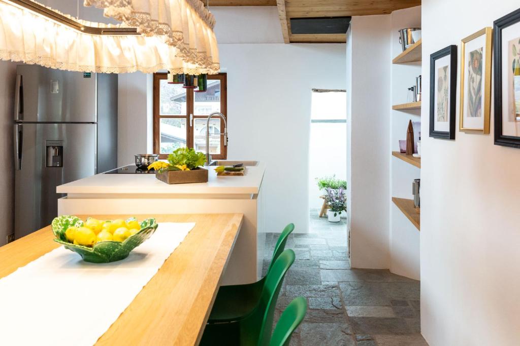 a kitchen with a table with a bowl of fruit on it at Historic Homes Zafig in Laces