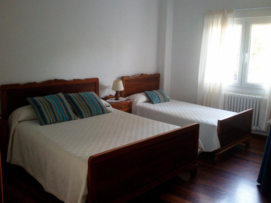 A bed or beds in a room at Hostal Pumar