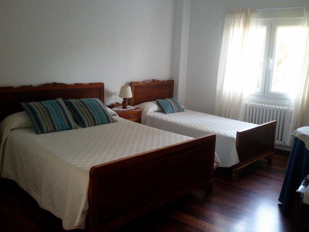 A bed or beds in a room at Hostal Pumar