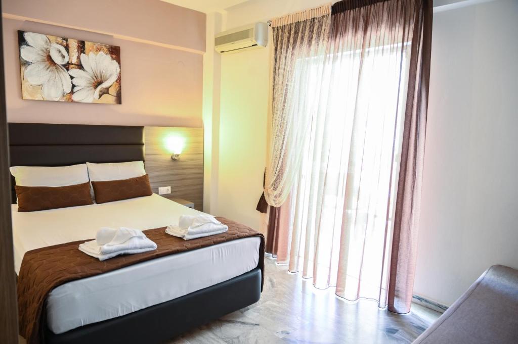 Posteľ alebo postele v izbe v ubytovaní Hotel Kostas