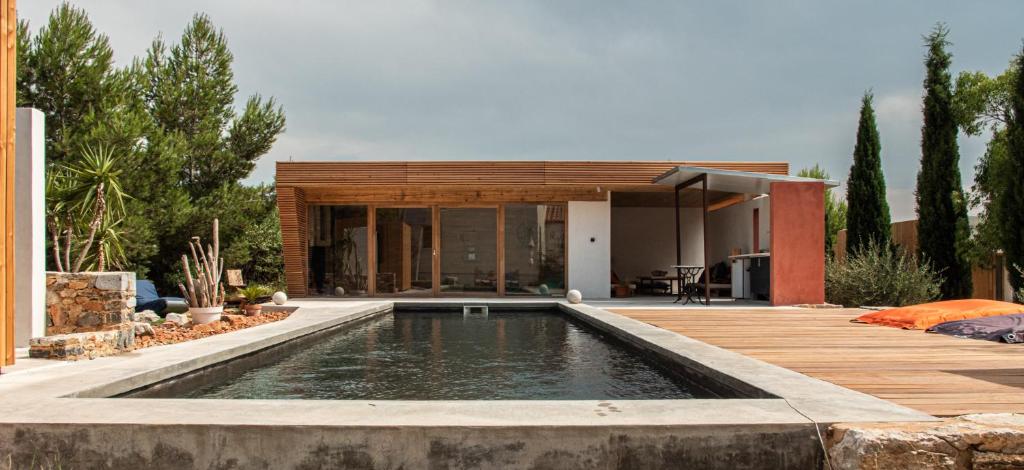 a house with a swimming pool in front of a house at 4u Bed & Spa in Opoul-Périllos