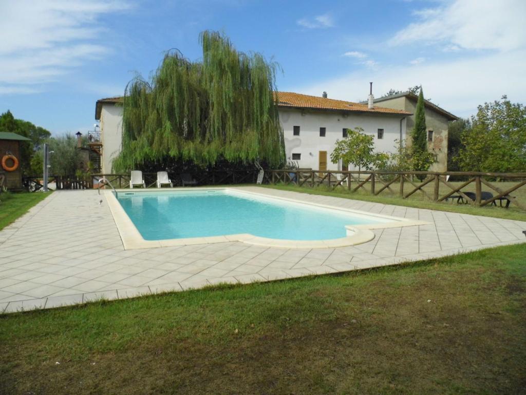 a swimming pool in the yard of a house at Agriturismo Le Baccane in Vinci