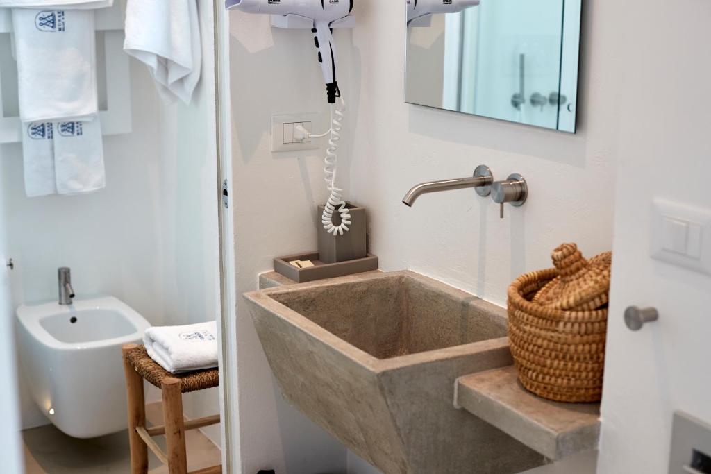 a bathroom with a large tub and a sink at Musae Relais & SPA in Polignano a Mare