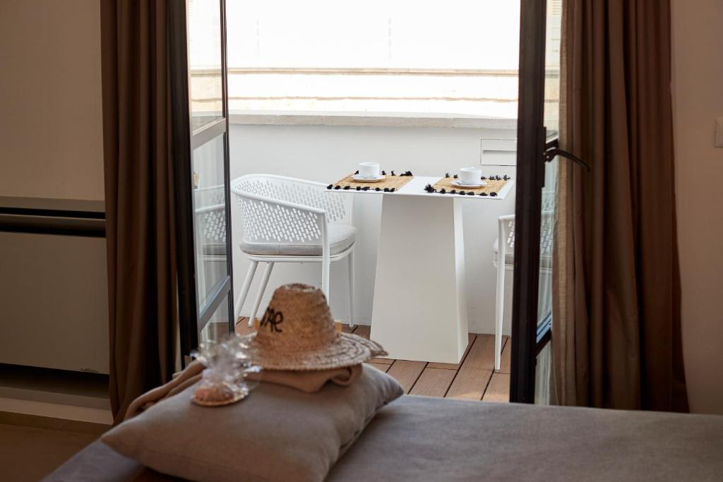 a hat sitting on a pillow on a bed in a room at Musae Relais & SPA in Polignano a Mare